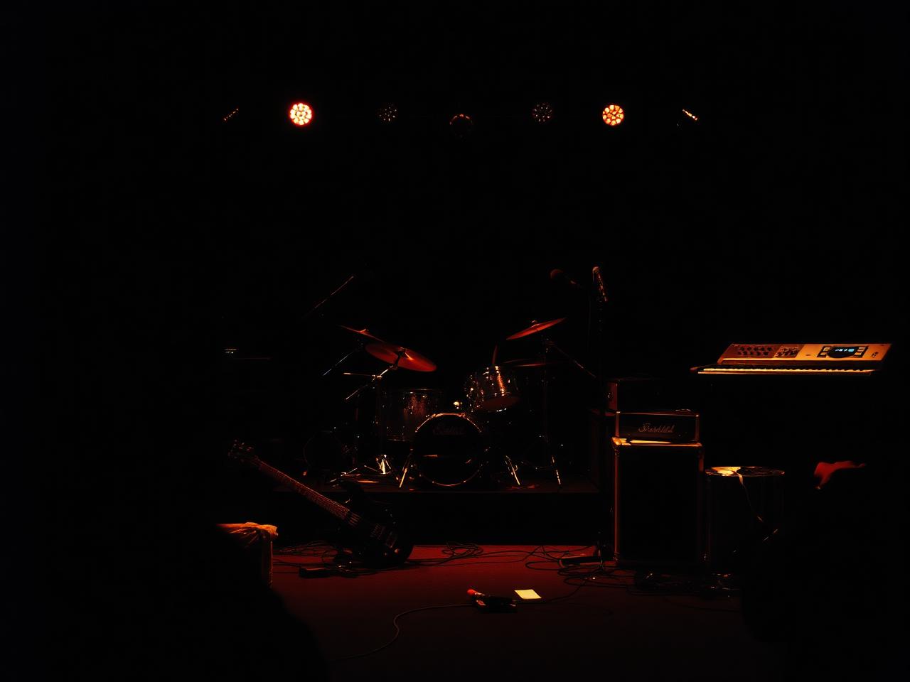 Backline instruments and amplifiers staged on a dark stage